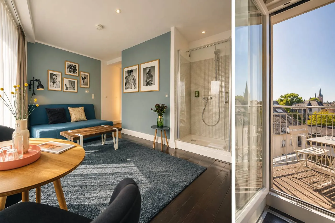 Wohnbereich der Suite mit Sofa, Esstisch und Dusche sowie Balkon mit Blick über Köln